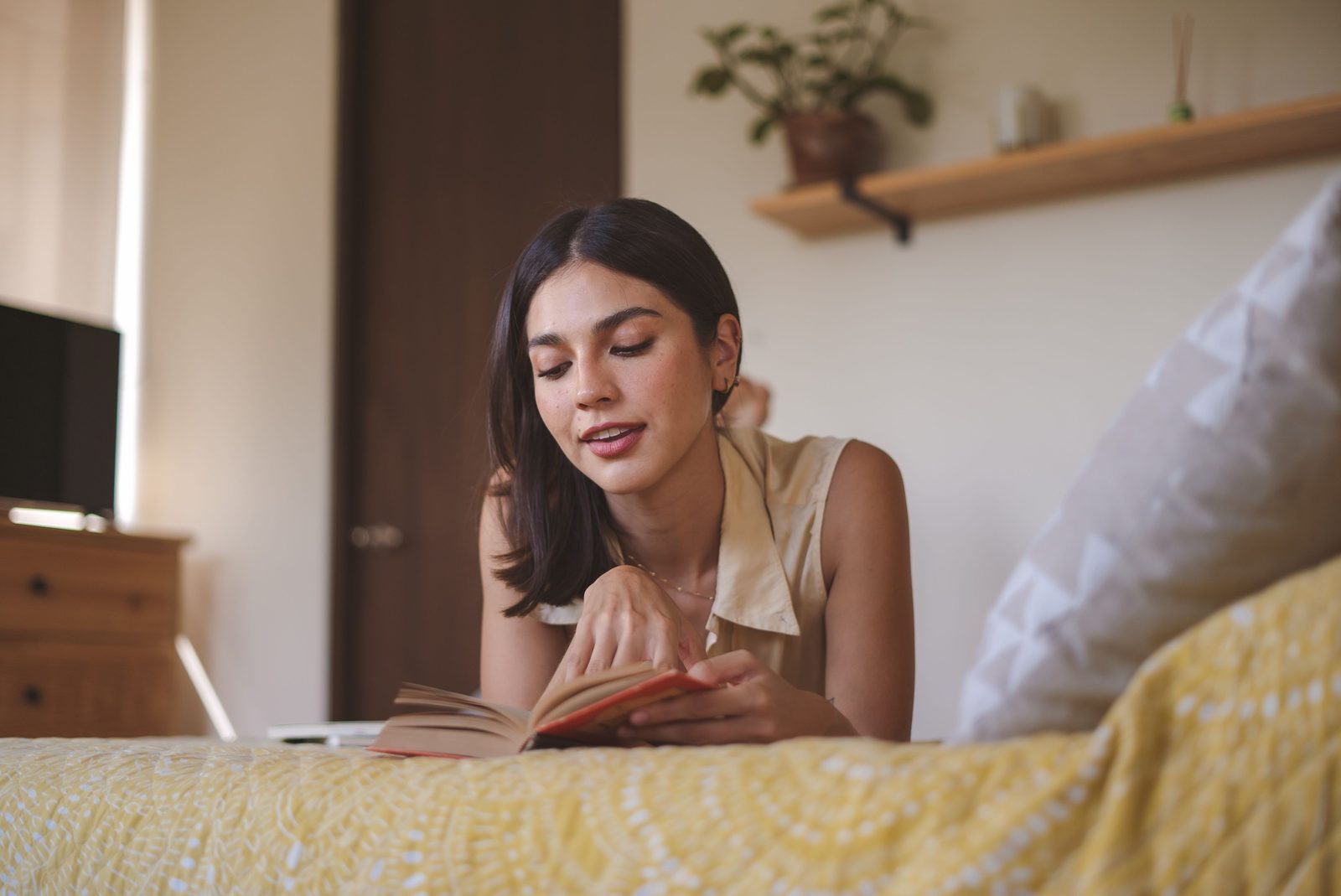 A woman reading calmly at home, able to focus and stay present